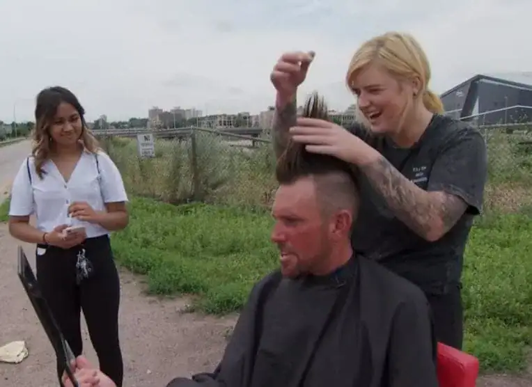 Hair stylist lugs red salon chair to city streets to bless homeless with free haircuts