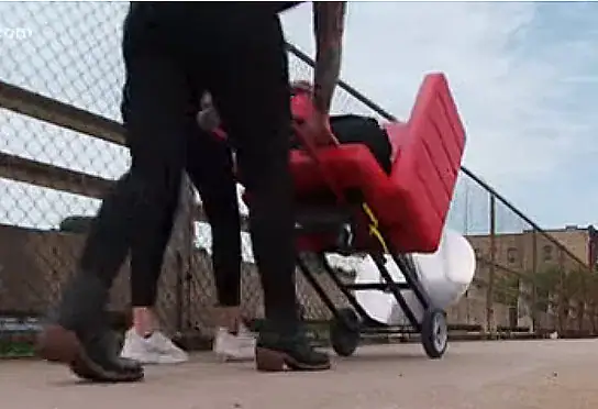 Hair stylist lugs red salon chair to city streets to bless homeless with free haircuts