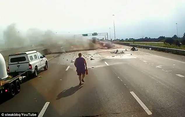 Trucker runs straight towards a fiery crash – dash cam captures moment he opens the car door