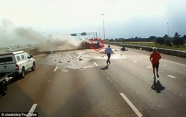 Trucker runs straight towards a fiery crash – dash cam captures moment he opens the car door