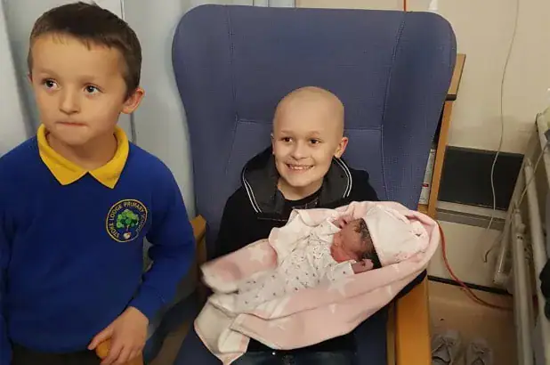 Boy with terminal cancer defies odds, hangs on to meet baby sister before dying on Christmas Eve