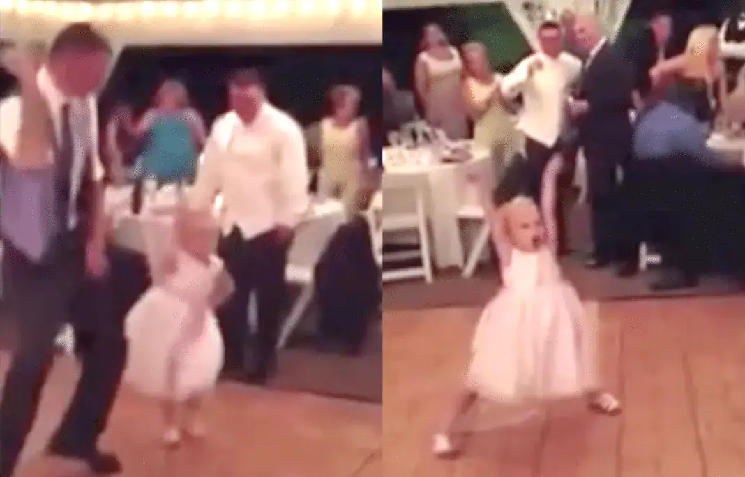 Flower girl having a blast dancing at wedding reception