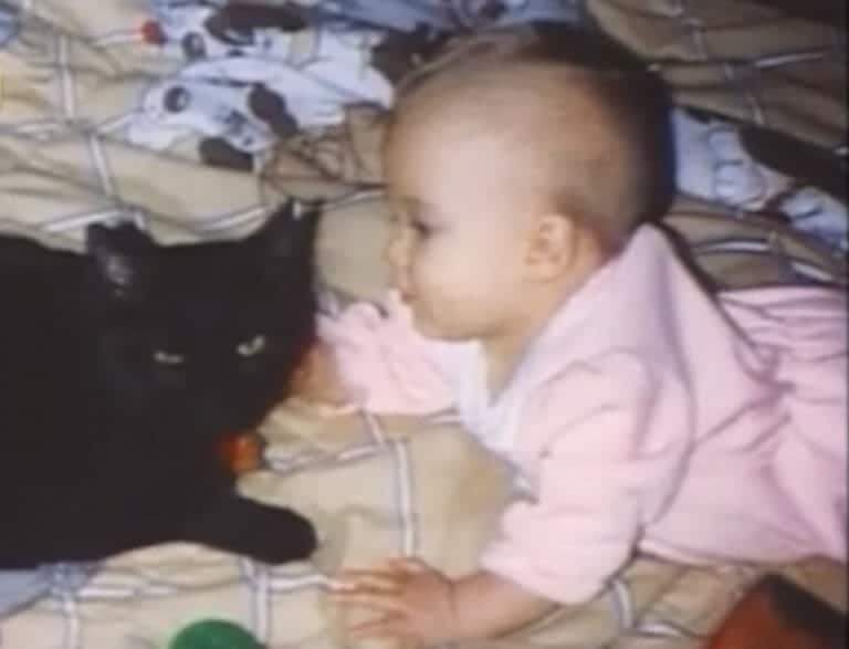 Mom hears kitty making strange noises over baby monitor, checks bedroom and leaps for the phone