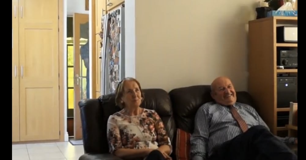 Grandparents Watch Slideshow Of New Grandson, Have No Idea He’s Right Next To Them