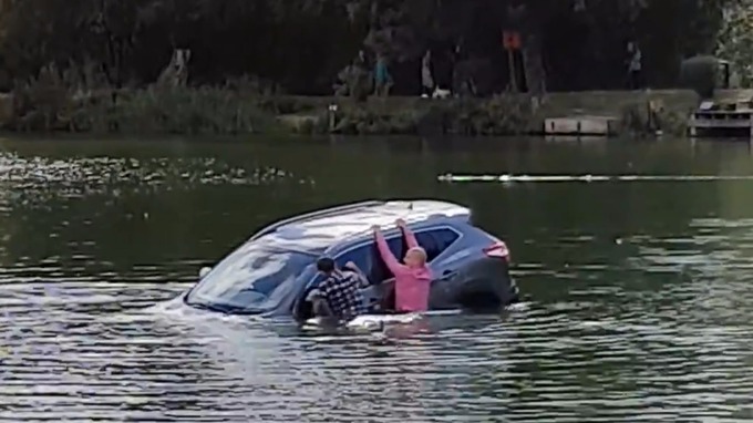 Eventually the passers-by managed to get the pensioner out of the car before it sank. Credit: SWNS