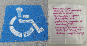 Handicapped parking sign and handwritten note