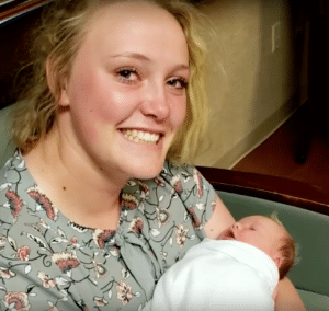 Morlie Hayes holds the baby she delivered