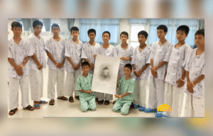 Thai cave, Wild Boars, rescued kids hold drawing of Saman Kunan