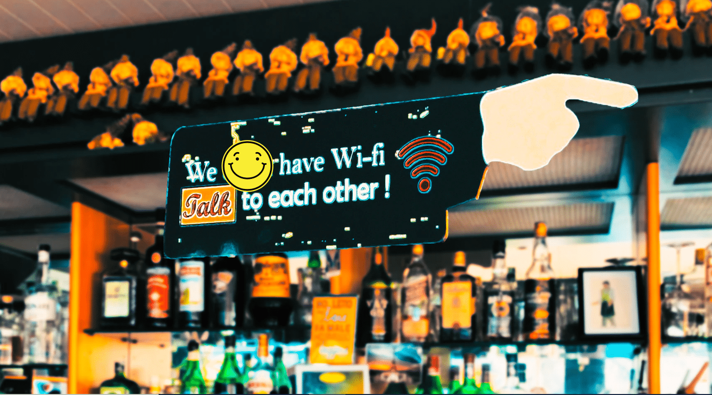sign saying "we have Wi-Fi, talk to each other" with a smiley face in a virtual bar